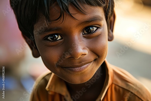 Portrait of a smiling little boy with big eyes in the village photo