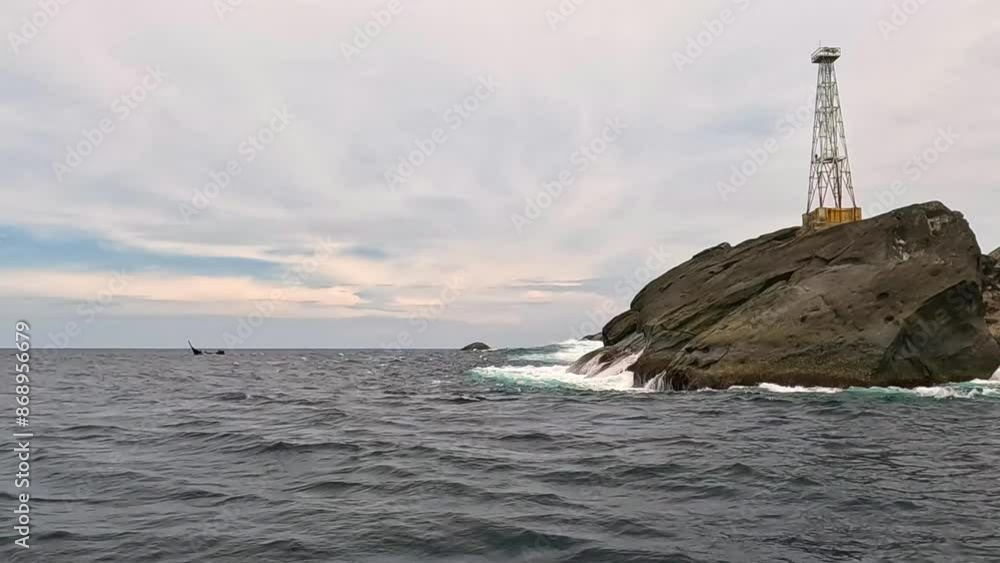 View of Coral Island with lighthouse in the sea from a boat. Fish and fishery concept. View of Coral Island with lighthouse in the sea from a boat. Fish and fishery concept.