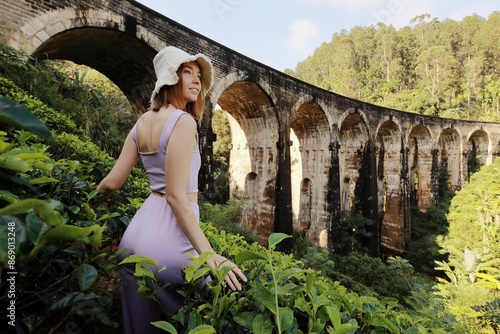A young woman enjoying the Nine Arch Bridge view traveling in Sri Lanka.