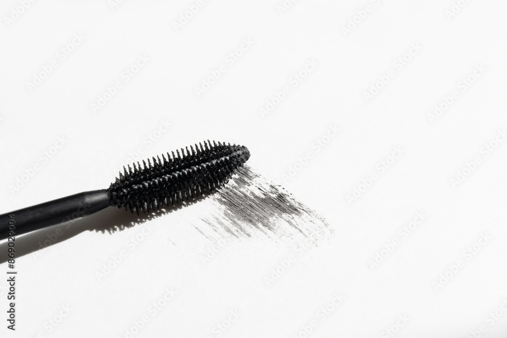 Black mascara with mascara brush on white background Black mascara with mascara brush on white background