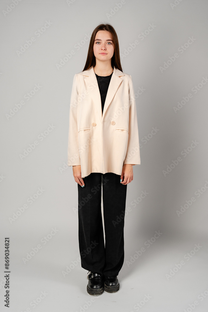 Woman Standing in Black Shirt and Pants on gray background Woman Standing in Black Shirt and Pants on gray background