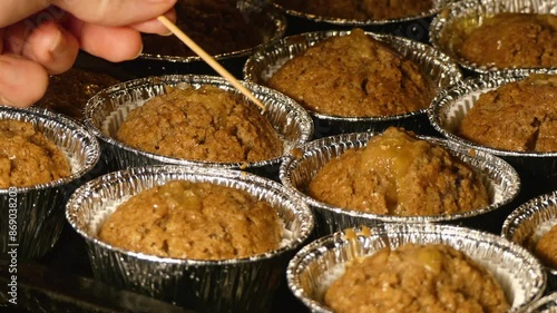 Testing Cupcakes with Care to Check for Baking Perfection