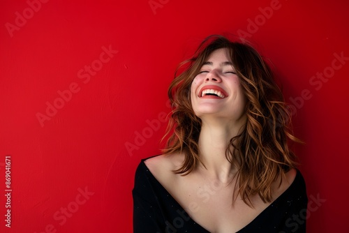 Portrait of beautiful caucasian woman laughing and looking away isolated on red background