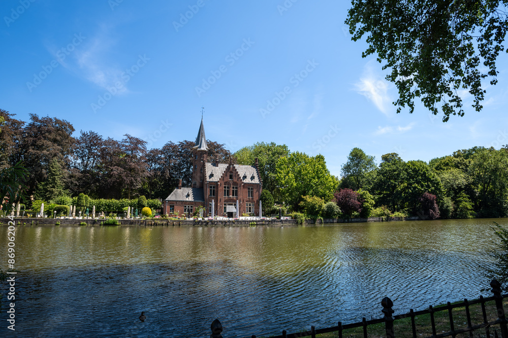 Minnewater Castle by the Lake of Love on a Sunny Day - Bruges, Belgium Minnewater Castle by the Lake of Love on a Sunny Day - Bruges, Belgium