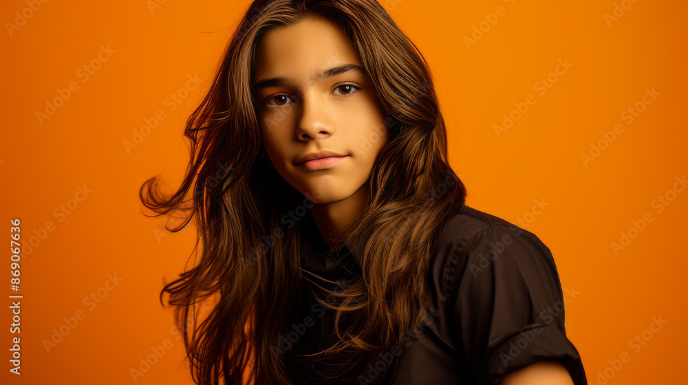 Happy cheerful young latino generation z. Smiling ethnic cool generation z teenage student, long hair, orange background. Happy cheerful young latino generation z. Smiling ethnic cool generation z teenage student, long hair, orange background.