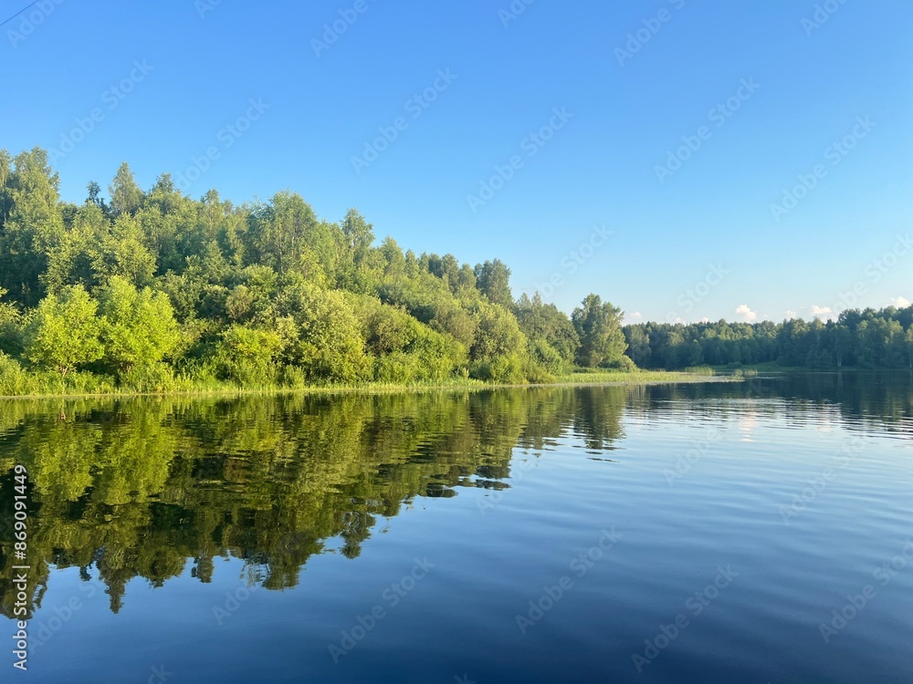 beautiful lake on the shore forest with reflection in water blue sky in reflection of water. beautiful lake on the shore forest with reflection in water blue sky in reflection of water.