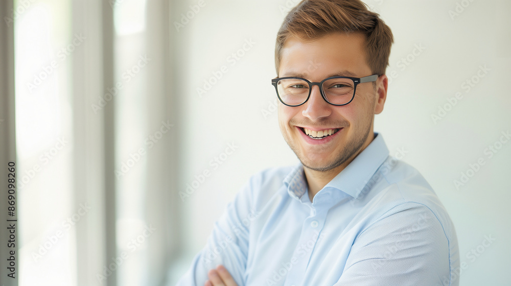 Young confident man wearing glasses in the office looking confident and smiling Young confident man wearing glasses in the office looking confident and smiling