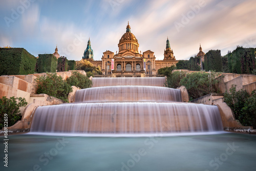 A stunning view of the majestic Montjuic National Palace taken at sunset with the three level waterfall to give a touch of magnificence to the fantastic architecture