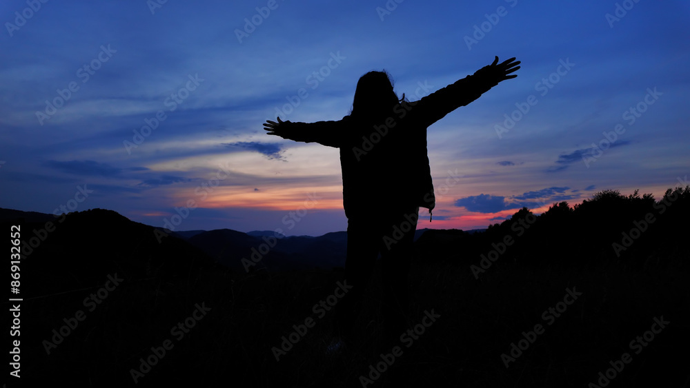 Silhouette of a woman with arms wide open in nature. Silhouette of a woman with arms wide open in nature.
