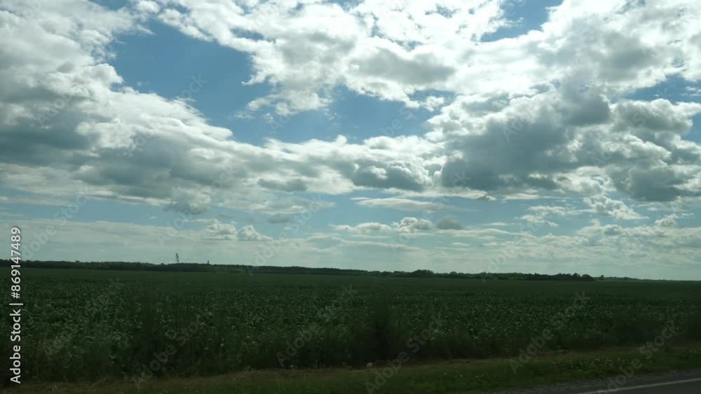 View from inside the car of nature, beautiful fields and cloudy blue sky while traveling by car on a sunny summer day. View from inside the car of nature, beautiful fields and cloudy blue sky while traveling by car on a sunny summer day.