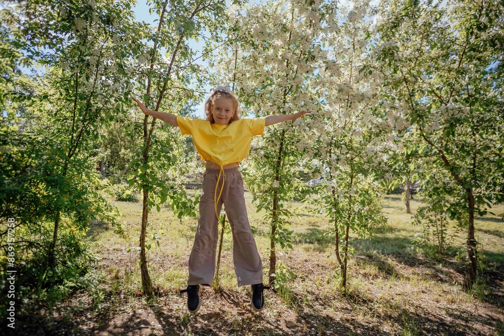 Happy girl jumping in front of trees at park Happy girl jumping in front of trees at park