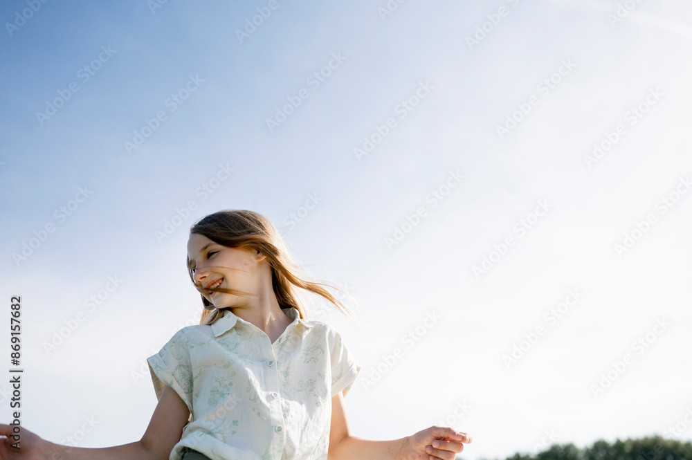 Carefree girl dancing under clear sky Carefree girl dancing under clear sky