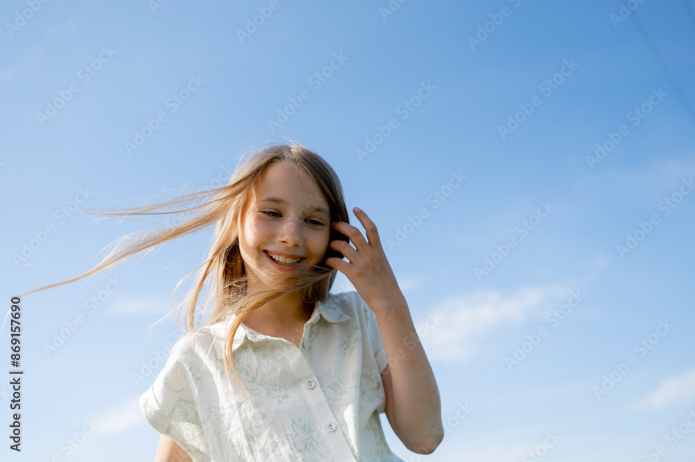 Happy girl with tousled hair under blue sky Happy girl with tousled hair under blue sky