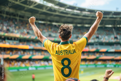 Australian Cricket Fans in Full Support. A diverse group of young Australian fans with fair skin, wearing bright yellow and green cricket gear, exuding happiness and enthusiasm in a stadium setting.
