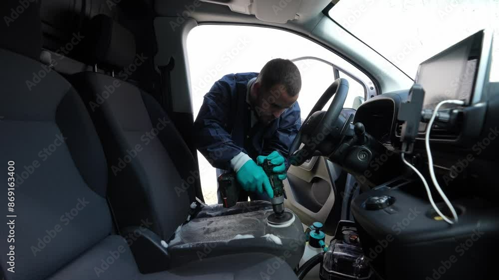 Man Using Power Brush to Clean Car Seat