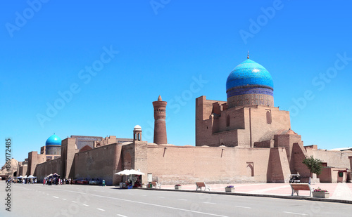 Dome with azure tile of Poi Kalyan Mosque and Kalyan minaret, religious complex of Chor Bakr, Bukhara, Uzbekistan. On blue sky background photo