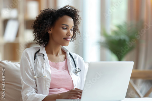 Pregnant woman consults gynecologist online for prenatal care via laptop, telemedicine.