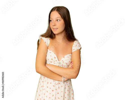 Pretty girl in casual dress standing with arms folded over transparent background.