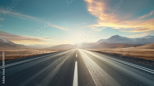 The sun is setting over a highway with mountains in the background,View of asphalt road with beautiful sunset in the evening,Road Leading Into A Sunset, Straight road to the mountain   © kaneez
