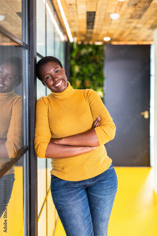 Smiling businesswoman leaning with arms crossed at office Smiling businesswoman leaning with arms crossed at office