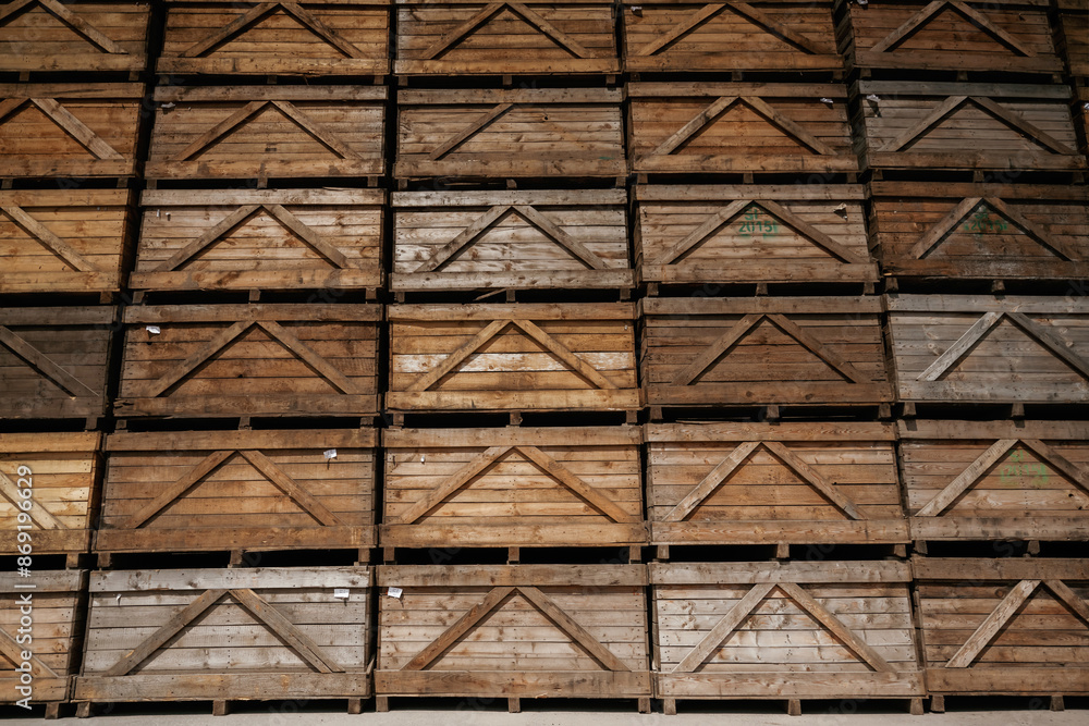 Stacked wooden crates in an organized warehouse setting Stacked wooden crates in an organized warehouse setting