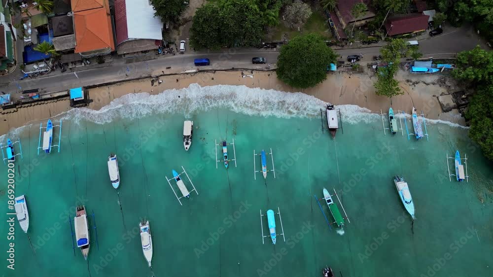 Birds Eye view of the blue water in Padang Bai bay and the traditional boats for tourists snorkelling and scuba trips Birds Eye view of the blue water in Padang Bai bay and the traditional boats for tourists snorkelling and scuba trips