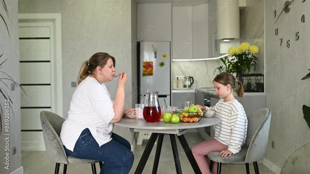Mom and daughter having healthy breakfast together Mom and daughter having healthy breakfast together