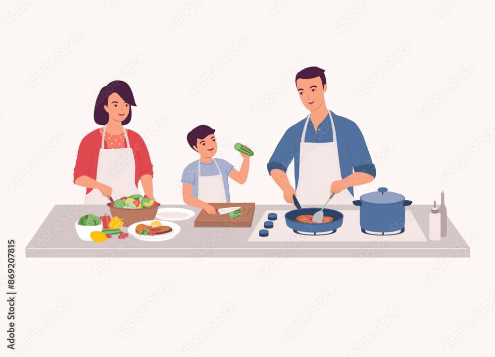 Family Preparing Food Together In The Kitchen. Smiling Little Son In Apron Cutting Cucumber With Knife. Father Cooking Steak With Frying Pan. Mother Making Salad. Family Preparing Food Together In The Kitchen. Smiling Little Son In Apron Cutting Cucumber With Knife. Father Cooking Steak With Frying Pan. Mother Making Salad.