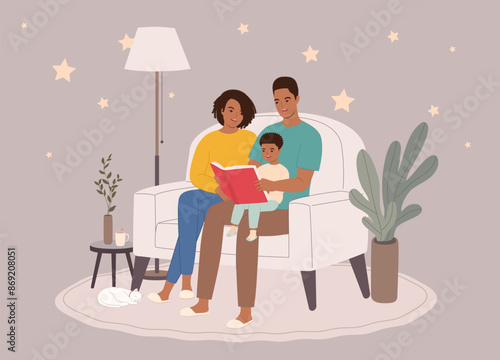 Smiling Black Parents Sitting On Couch Reading A Bedtime Story Together With Their Little Son During Night Time.