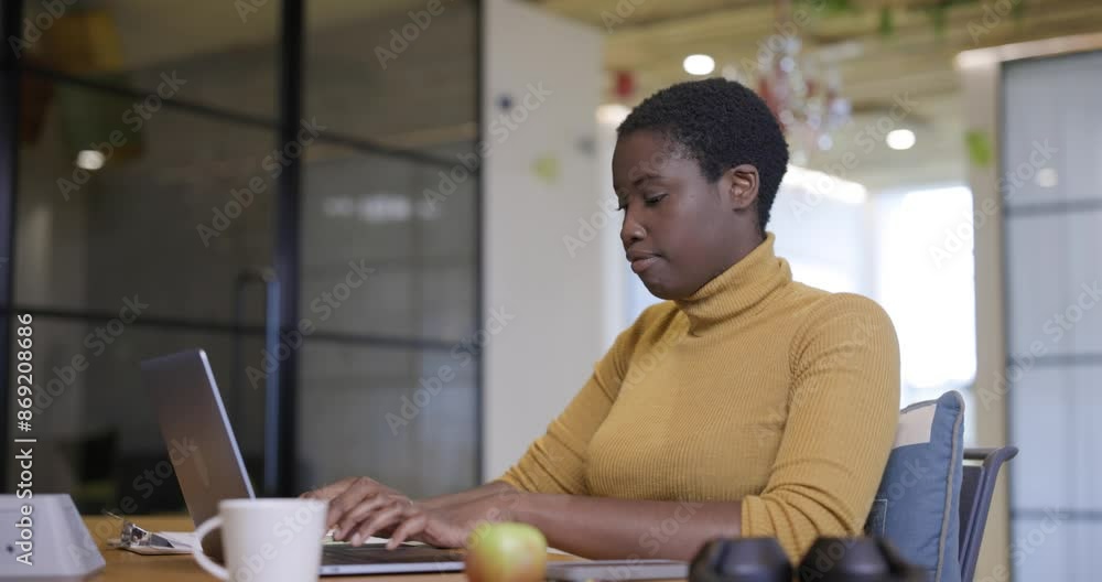 Businesswoman using laptop in office