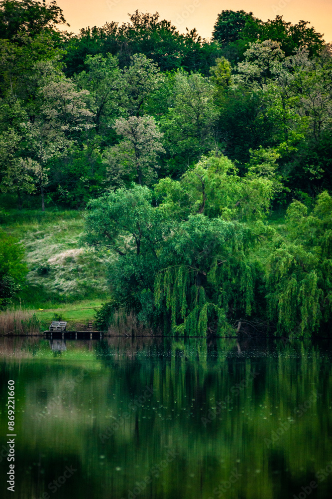 Sunset over the river . Another river beach. May and trees . Green colors . Reflections on water . Fising on river . Golden sunset Sunset over the river . Another river beach. May and trees . Green colors . Reflections on water . Fising on river . Golden sunset