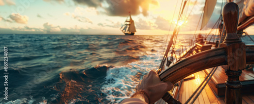 captain first person view of hands on the helm wheel, sailing ship in open ocean at sunset, wind blowing through sails photo