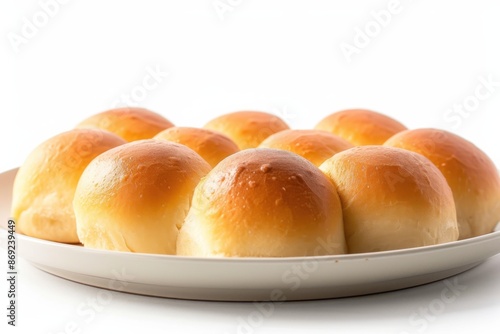 Freshly baked golden brown dinner rolls bread served on white background.