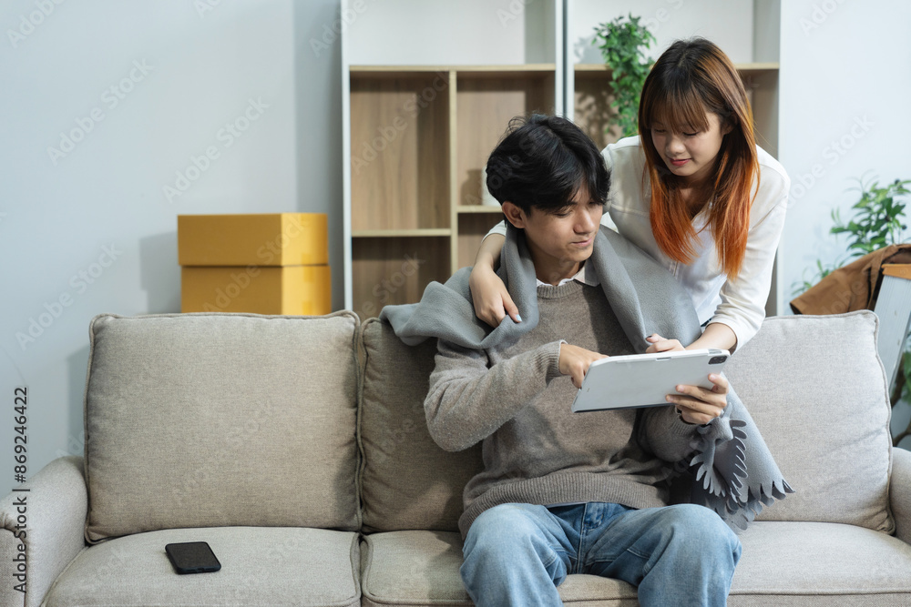 Young couple relaxing sitting on the floor around cardboard boxes at home, smiling happy moving to a new house. Young couple relaxing sitting on the floor around cardboard boxes at home, smiling happy moving to a new house.