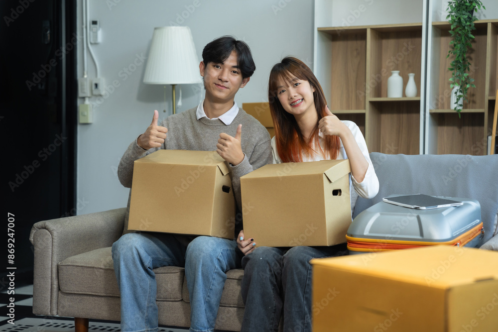 young couple helps put things in boxes and prepares to move to a new house.