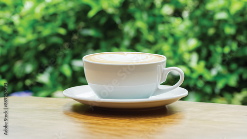 coffee cup in around coffee beans on Wooden tabletop with blurred tea plantation landscape against blue sky and blurred green leaf frame Product display concept natural background