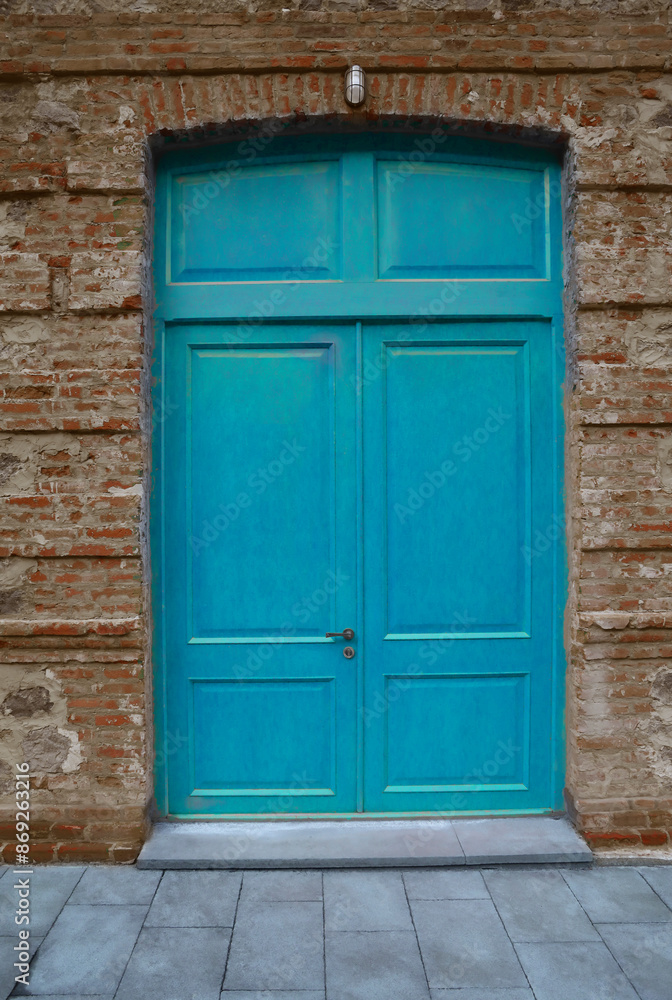 blue painted Wooden door gate in red brick stone arch. Old, vintage wood arched door in red brick wall. house home vintage retro aged exterior. grey tiled floor. front view. lantern aboму doorway blue painted Wooden door gate in red brick stone arch. Old, vintage wood arched door in red brick wall. house home vintage retro aged exterior. grey tiled floor. front view. lantern aboму doorway