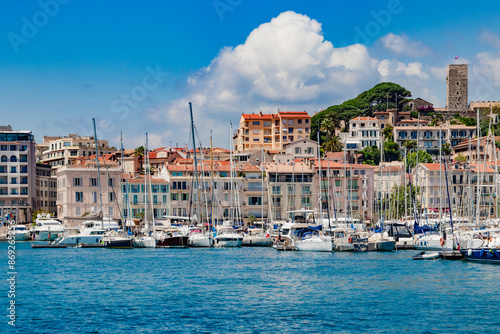 Obraz na płótnie Luxury yachts, modern buildings, and sailboats in a beautiful Mediterranean marina view. Old city and harbor in Cannes, French Riviera, France. w salonie