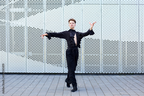 Professional male dancer in a black suit rehearsing ballroom choreography © makedonski2015