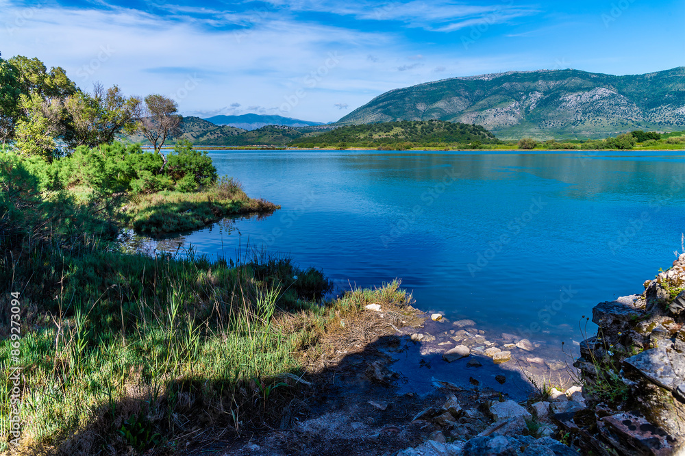 A view out across a freshwater lake beside the ancient ruins at Butrint, Albania in summertime A view out across a freshwater lake beside the ancient ruins at Butrint, Albania in summertime
