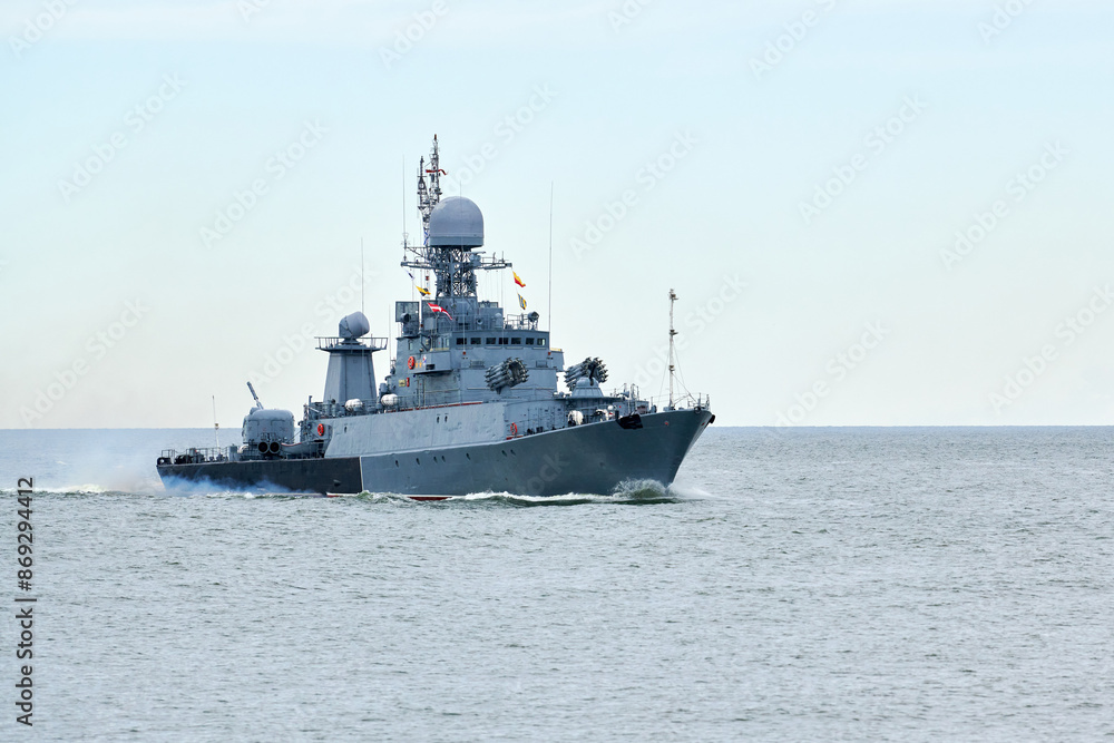 Russian warship armed with armament sails into sea toward military target to attack and destroy enemy, military ship performing strategic maneuver, Russian sea power deployment for tactical advantage Russian warship armed with armament sails into sea toward military target to attack and destroy enemy, military ship performing strategic maneuver, Russian sea power deployment for tactical advantage