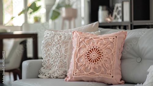Elegant crochet peach throw pillow with detailed mandala designs, adorning a contemporary sofa in a chic living room