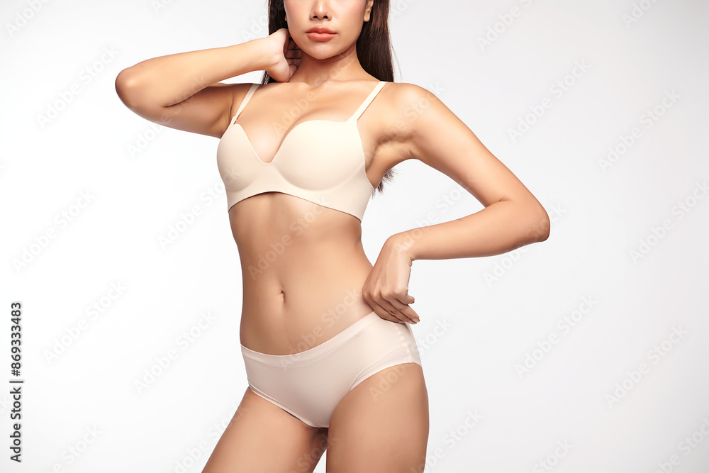 Naklejka premium Confident beautiful young asian woman posing in white lingerie on white background, Perfect body,