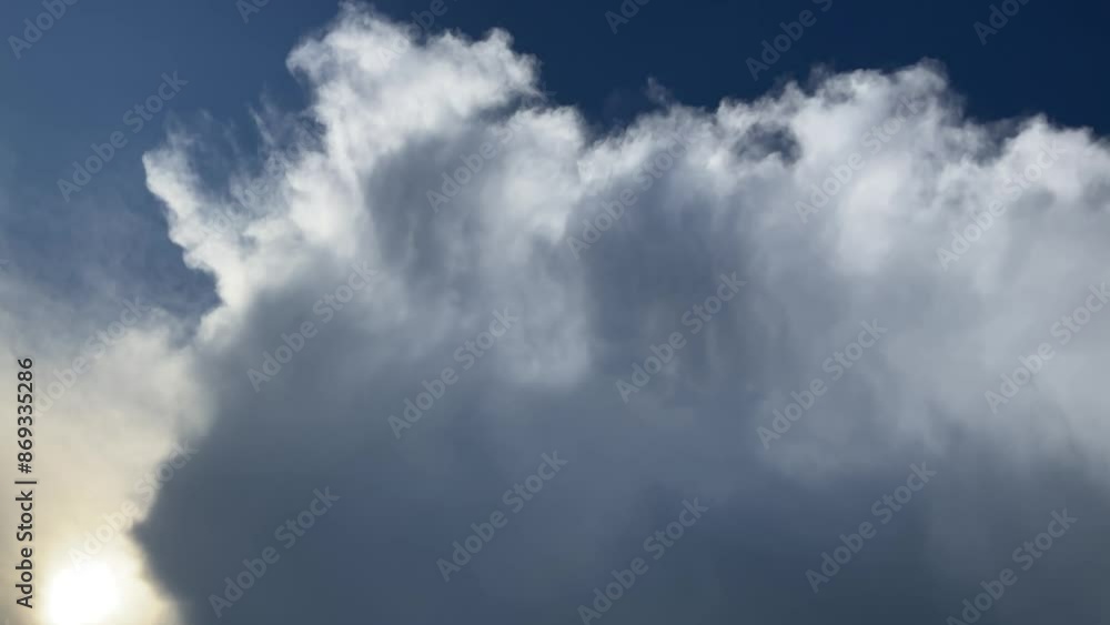Blue sky with sun and dark Cumulonimbus incus, Anvil cloud during stormy summer day - natural background, shot with camera movement. Topics: meteorology, atmosphere, space, season, weather change Blue sky with sun and dark Cumulonimbus incus, Anvil cloud during stormy summer day - natural background, shot with camera movement. Topics: meteorology, atmosphere, space, season, weather change