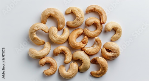 Twelve Cashew Nuts Arranged in Rows on a White Background