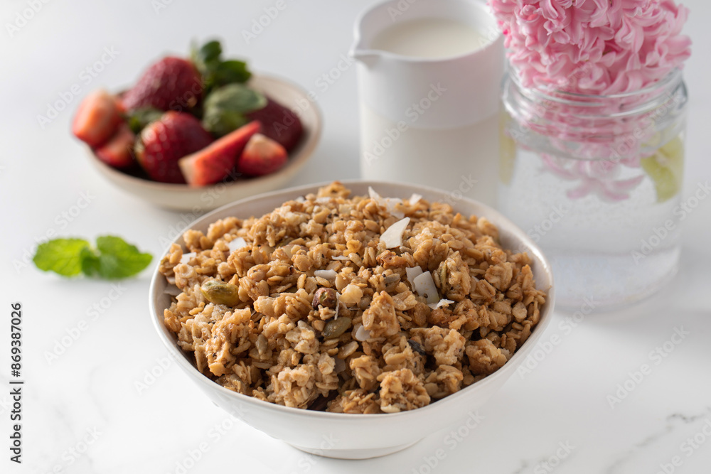 Crispy homemade granola with sliced almonds in a bowl with strawberries. Healthy eating Crispy homemade granola with sliced almonds in a bowl with strawberries. Healthy eating