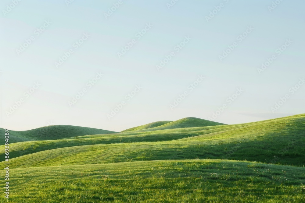 Naklejka premium A serene landscape depicting gentle rolling hills under a clear blue sky, creating a soothing and peaceful atmosphere.