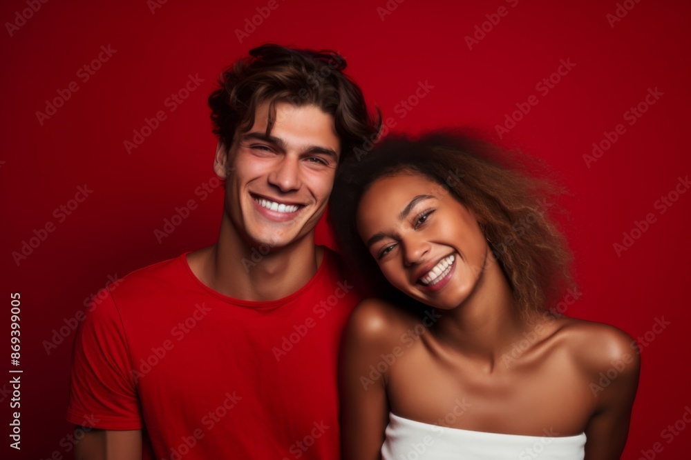 Smiling portrait of a young interracial couple on colorful background Smiling portrait of a young interracial couple on colorful background