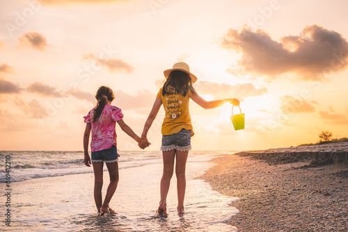 sunset stroll down Sanibel Island beaches with their shell bucket and a golden hour beach walk