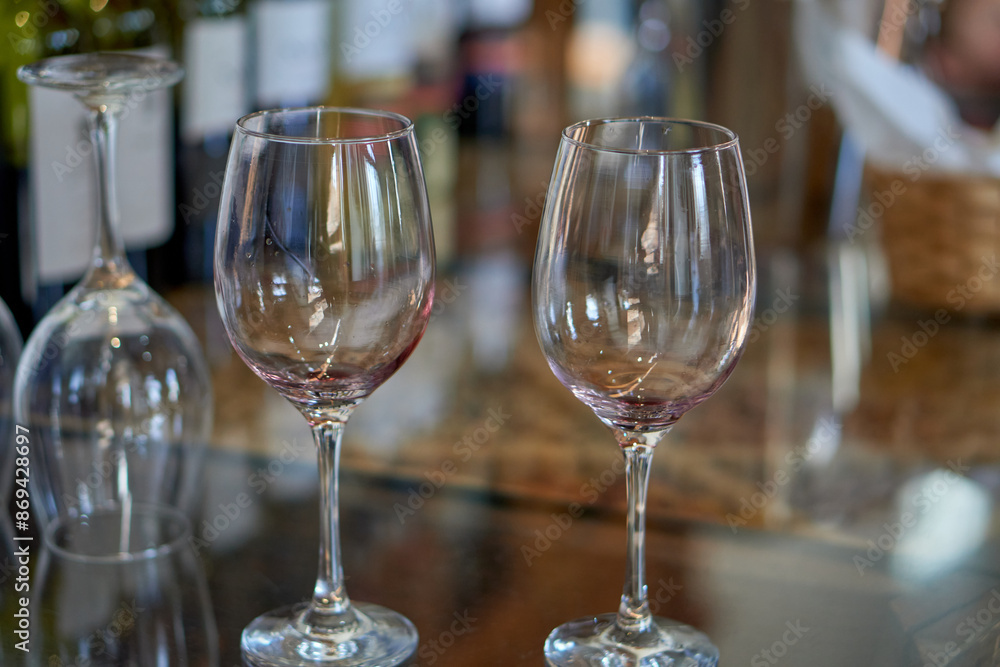 2 empty wine glasses on a table at a wine tasting in Cafayate, Argentina. Out of focus background